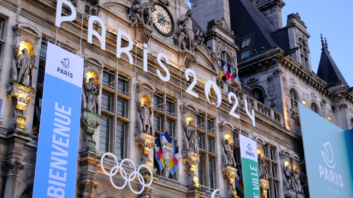 Paris building facade with Olympic banners and logo
