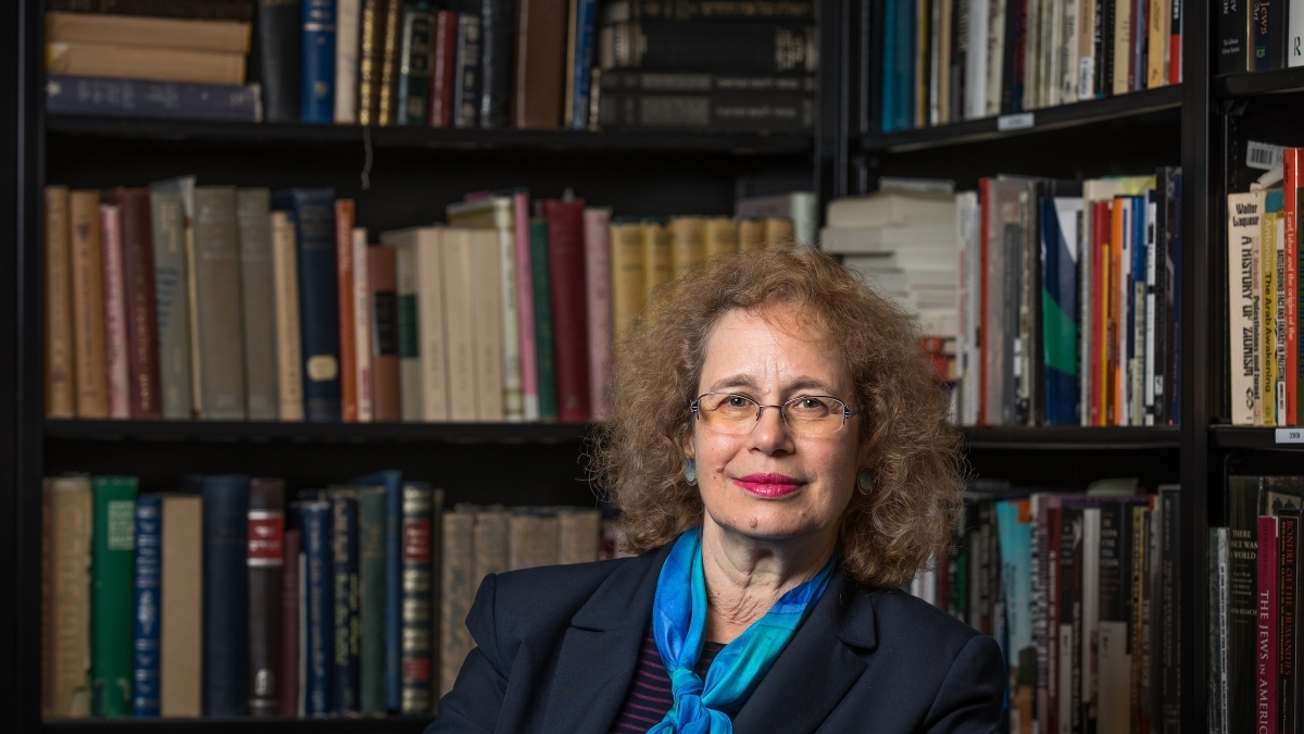 Hava Tirosh-Sameulson sits in front of bookshelves.