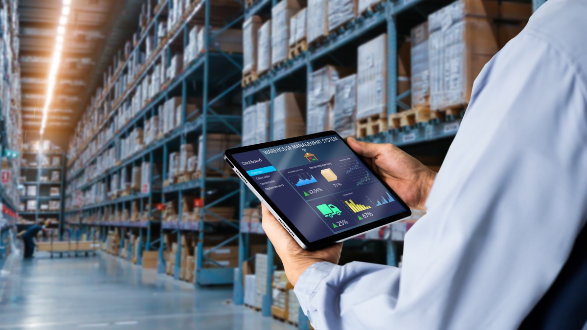 Person conducting warehouse inventory on a tablet