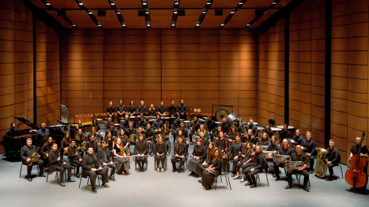 Wind band ensemble gathered onstage.