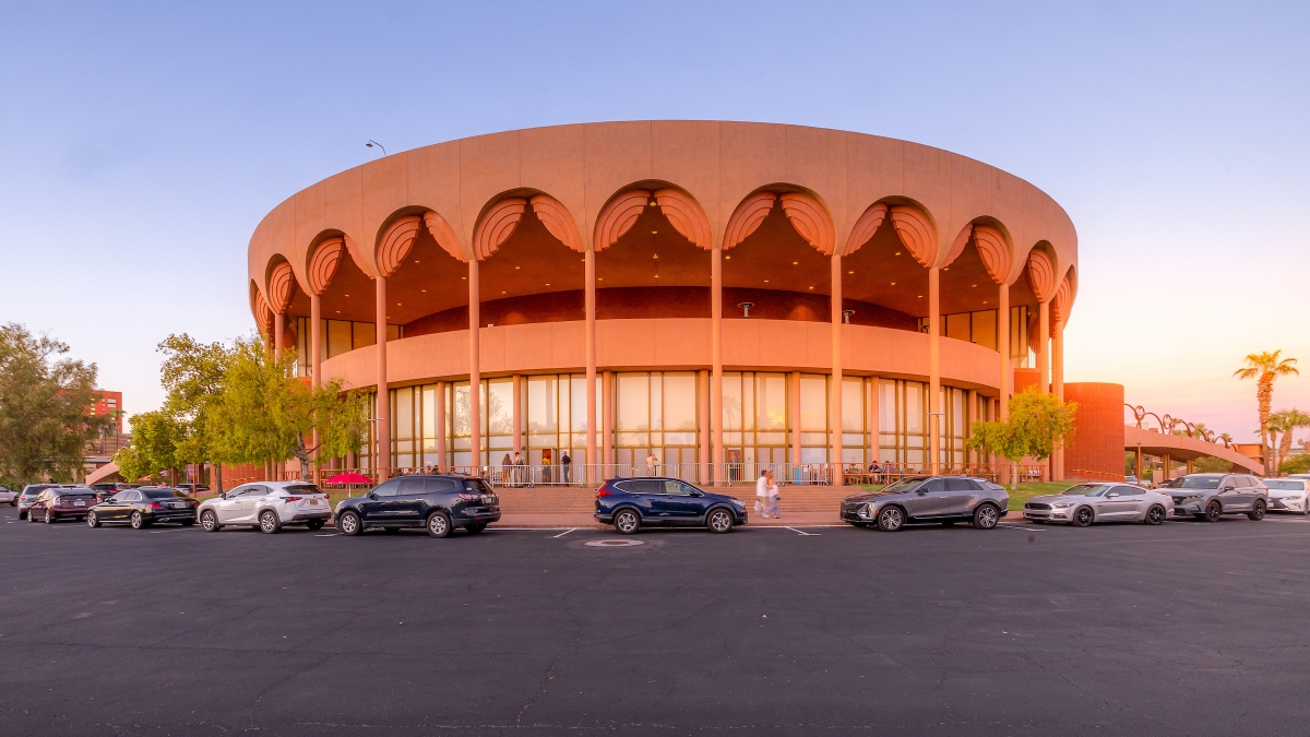 A round, pink building with arches