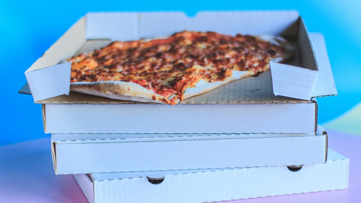 A stack of four pizza boxes