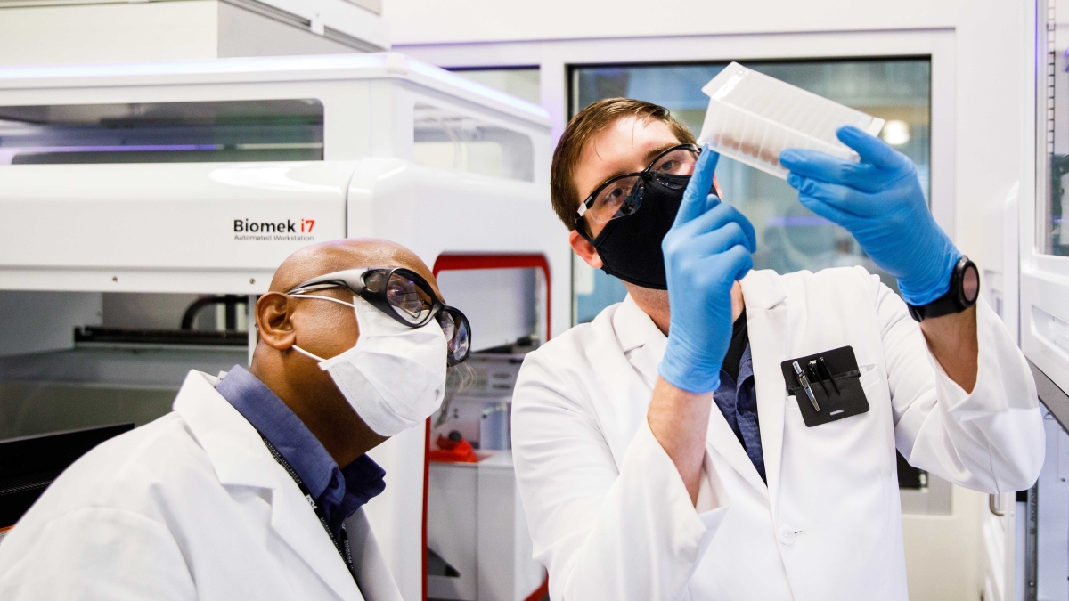 ASU clinical lab staff check a sample block before RNA isolation