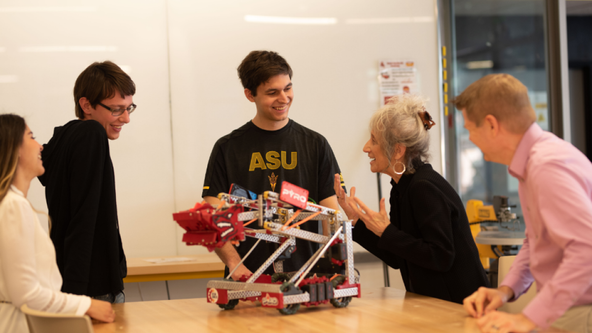 Students working with professor on robotics project