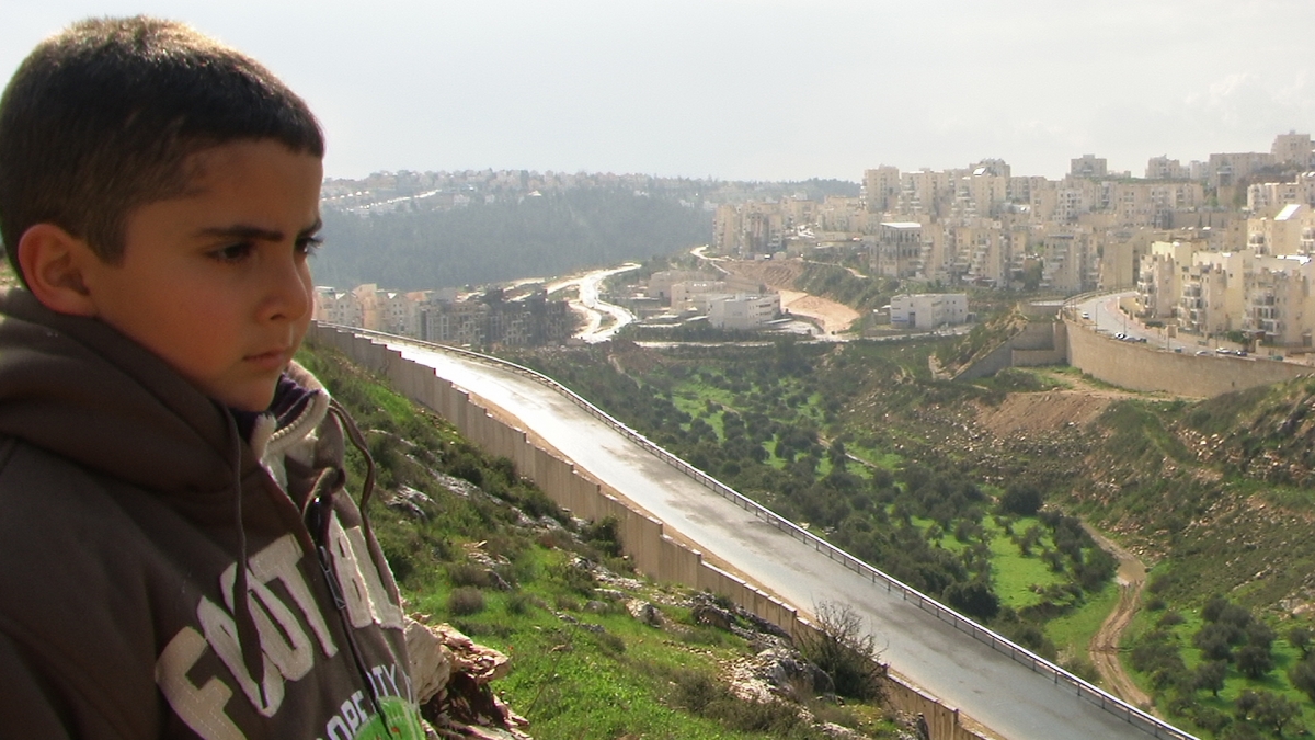 Palestinian filmmaker&#039;s son looks over at Israeli settlements from above