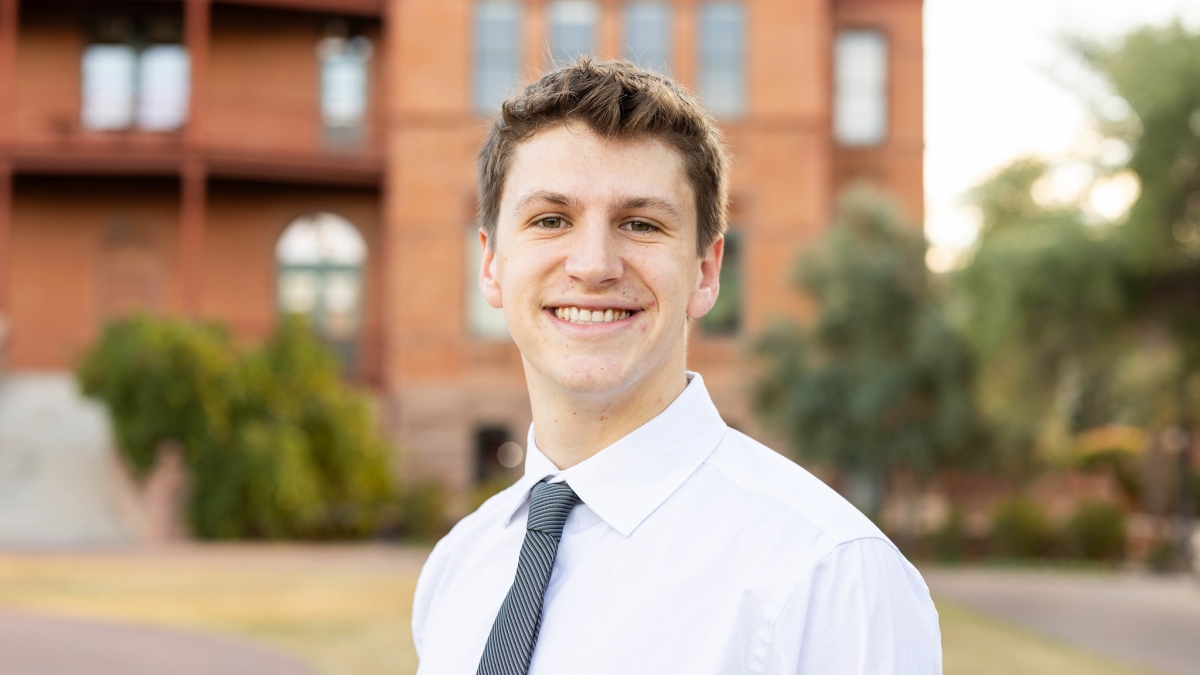 Headshot of Austin Adams in front of Old Main on Tempe campus.