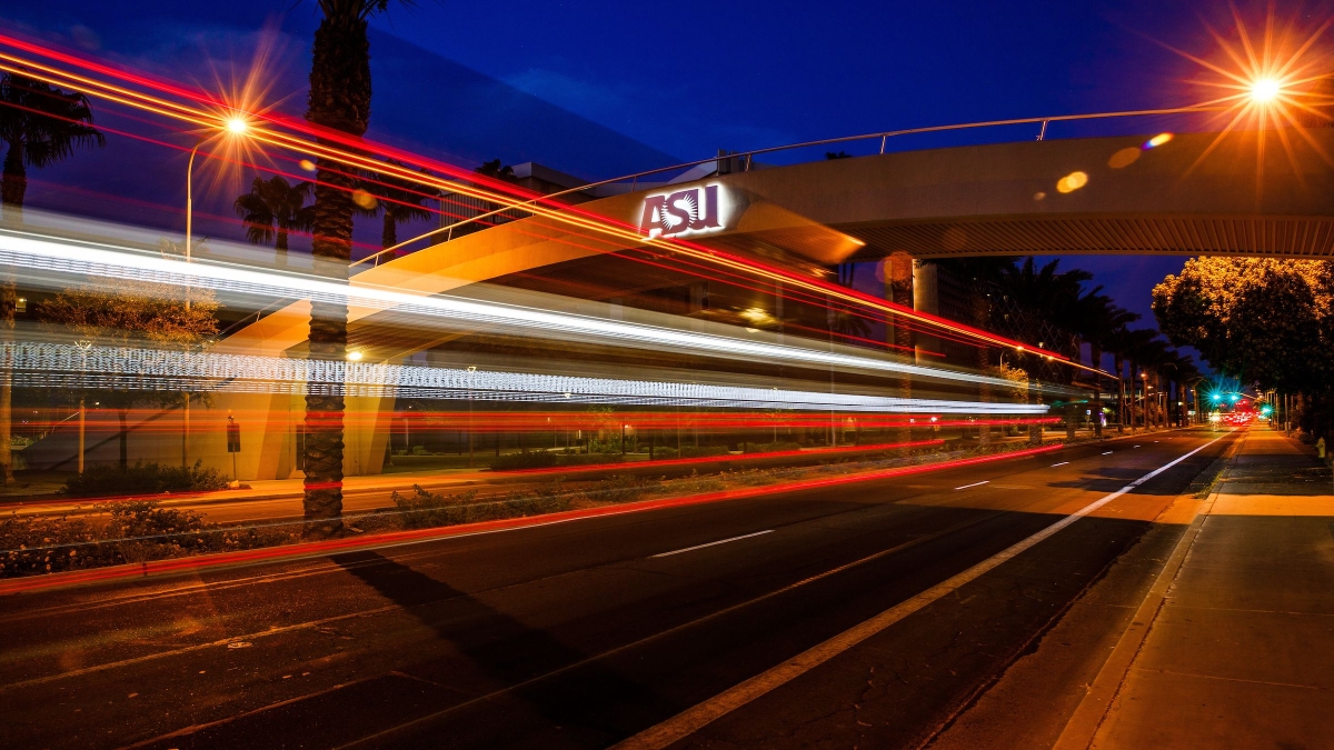 A timelapse photo of the ASU Tempe campus pedestrian bridge at night.