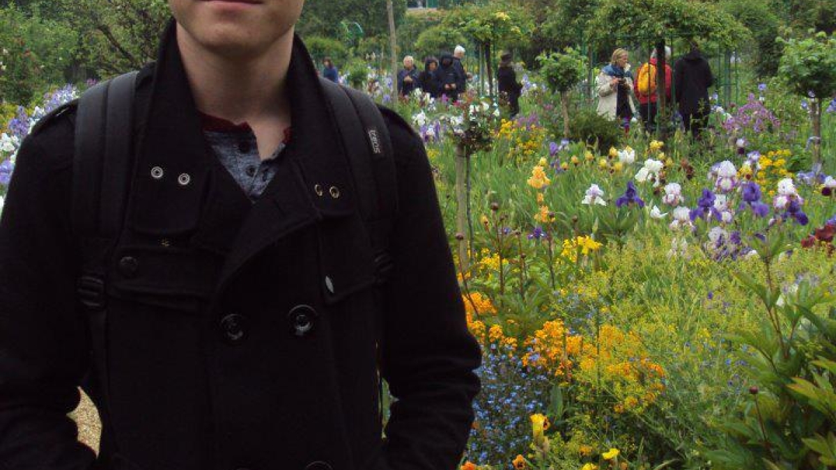 Jake Adler posing in a garden