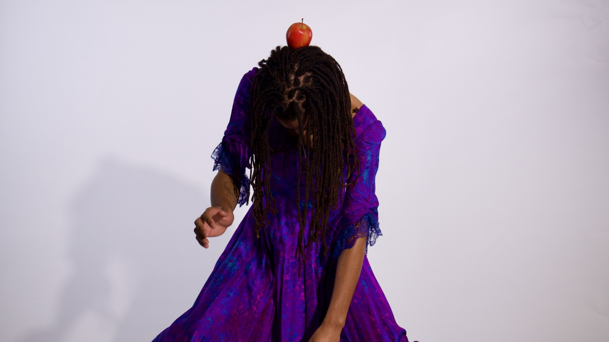 dancer with an apple on their head