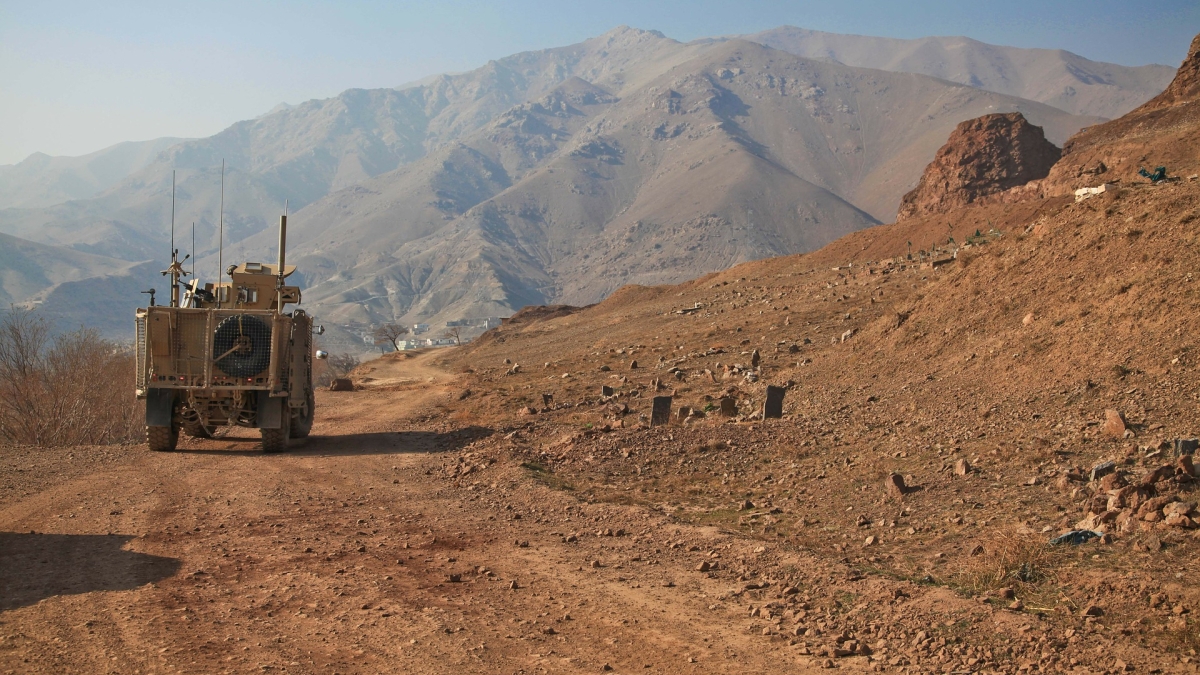 military truck driving through mountainous terrain