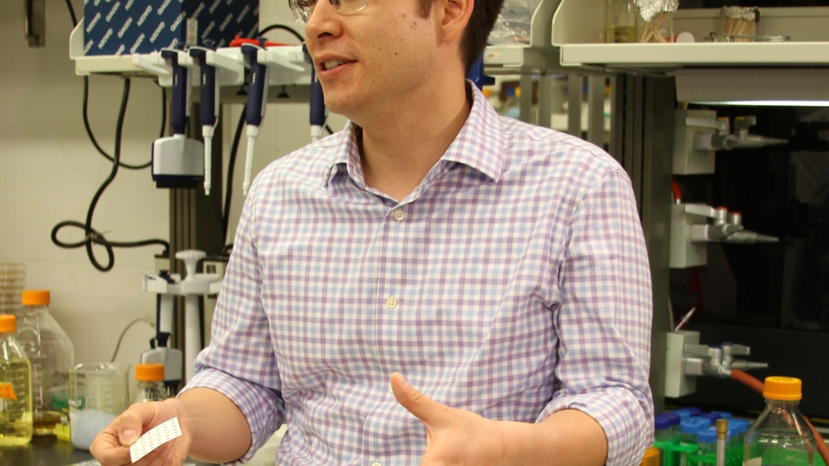 Alexander Green holds a paper-based diagnostic test for the Zika virus