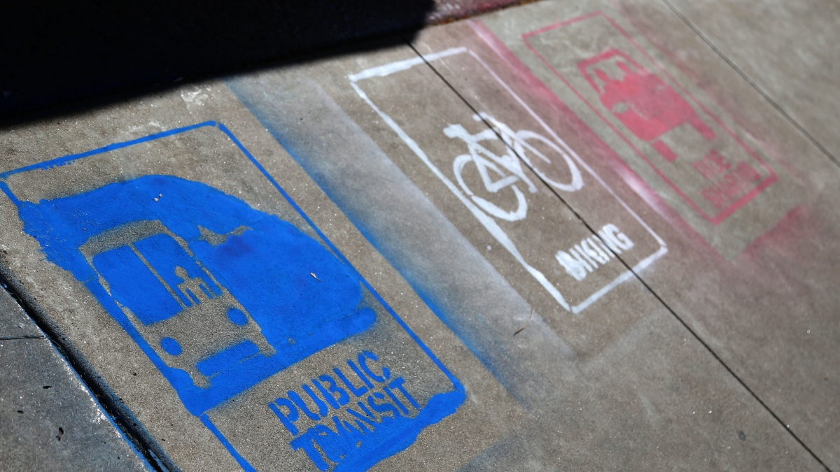 sidewalk painted with public transit signs