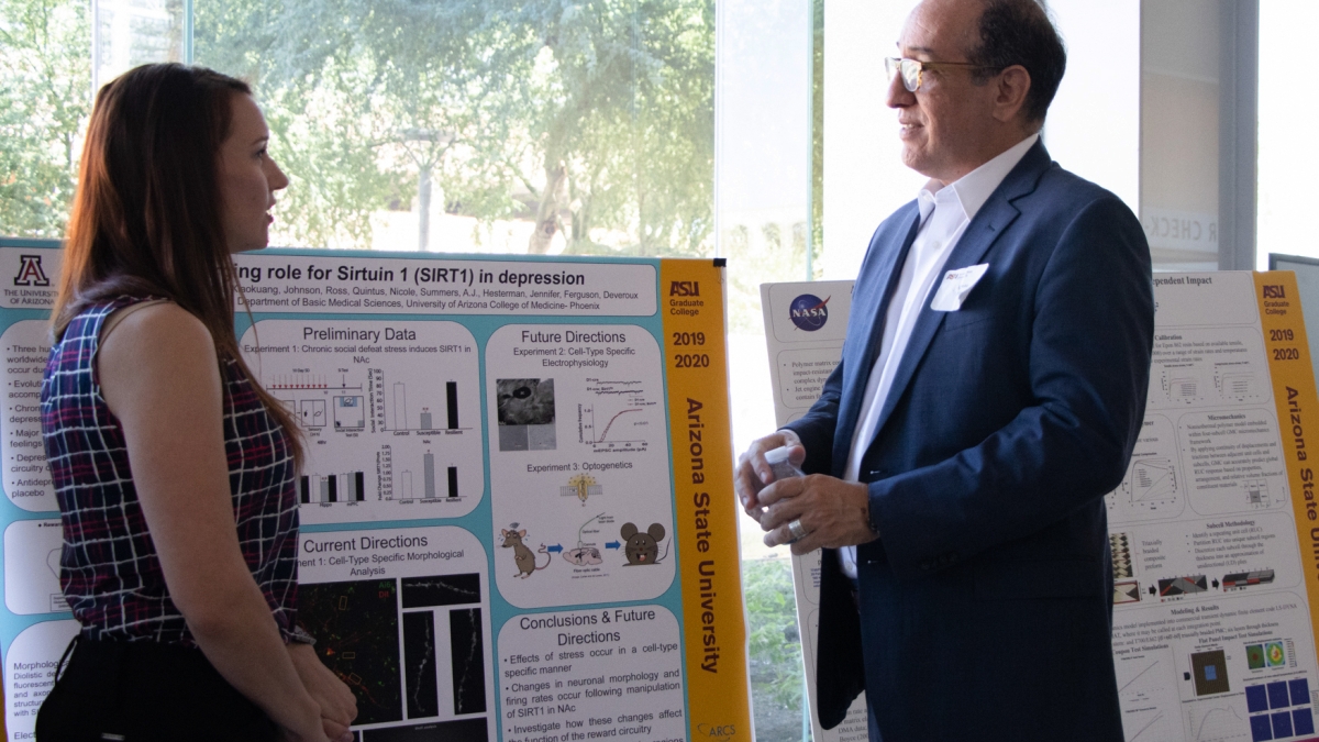 ARCS Scholar Tanessa Call discusses her research around the protein Sirtuin 1 with Arizona State University Graduate College Dean Alfredo J. Artiles. (Photo by Tyler Dunn/Graduate College)