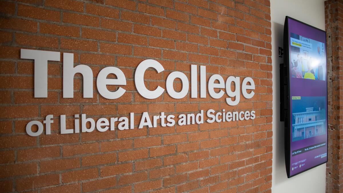 Sign on a brick wall that reads "The College of Liberal Arts and Sciences."