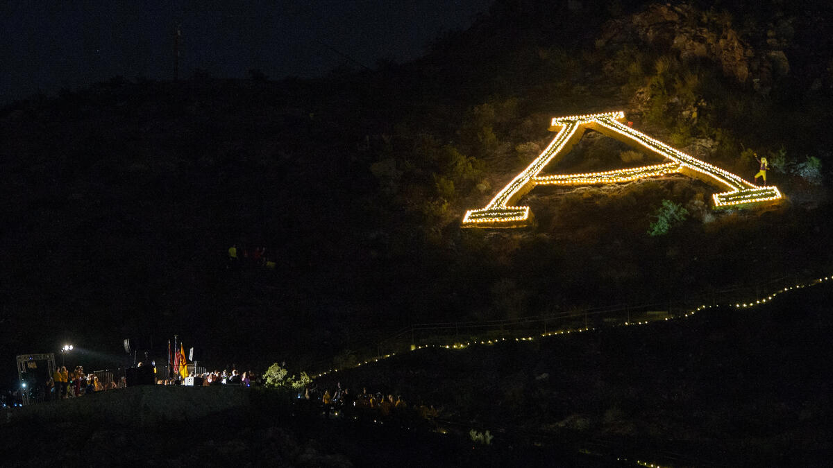 The A on A Mountain is outlined with lights held by students during the Lantern Walk