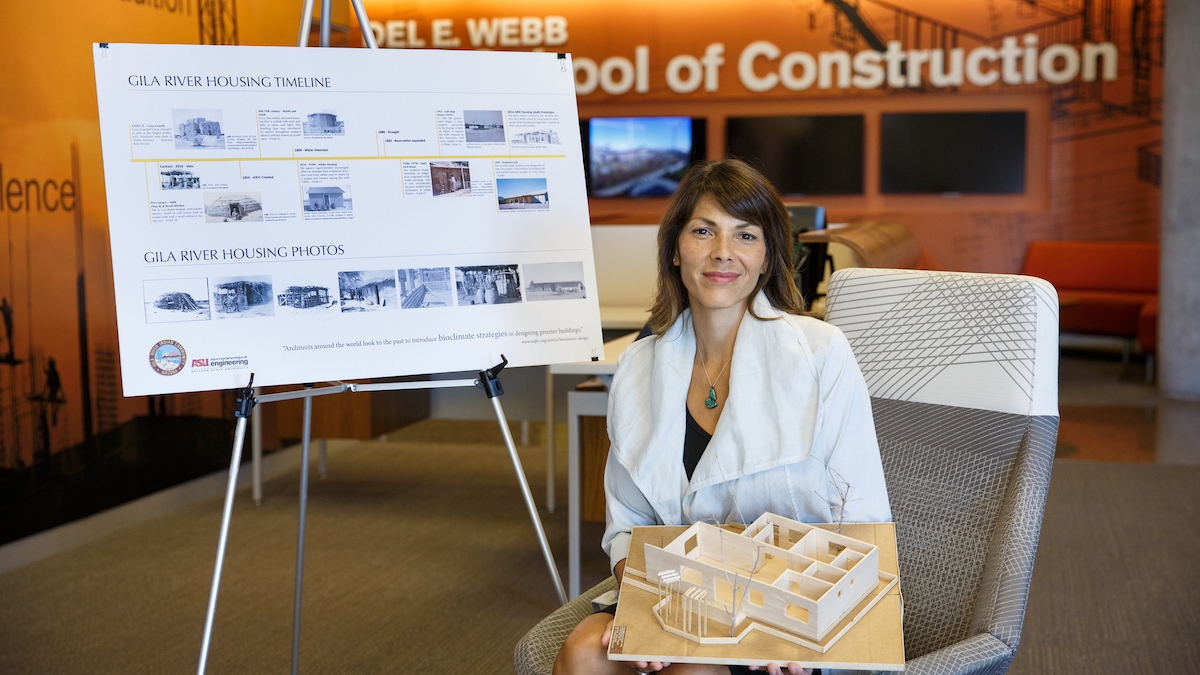 Woman smiling in front of board