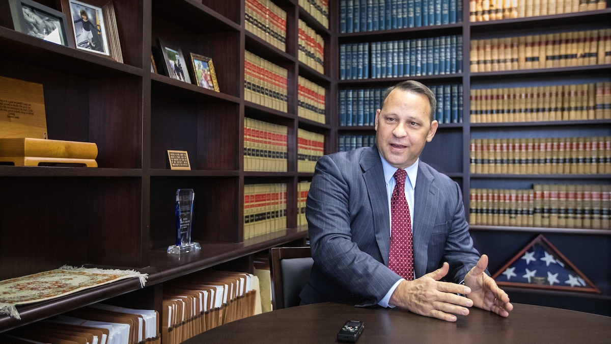 Man in suit and tie with law books 