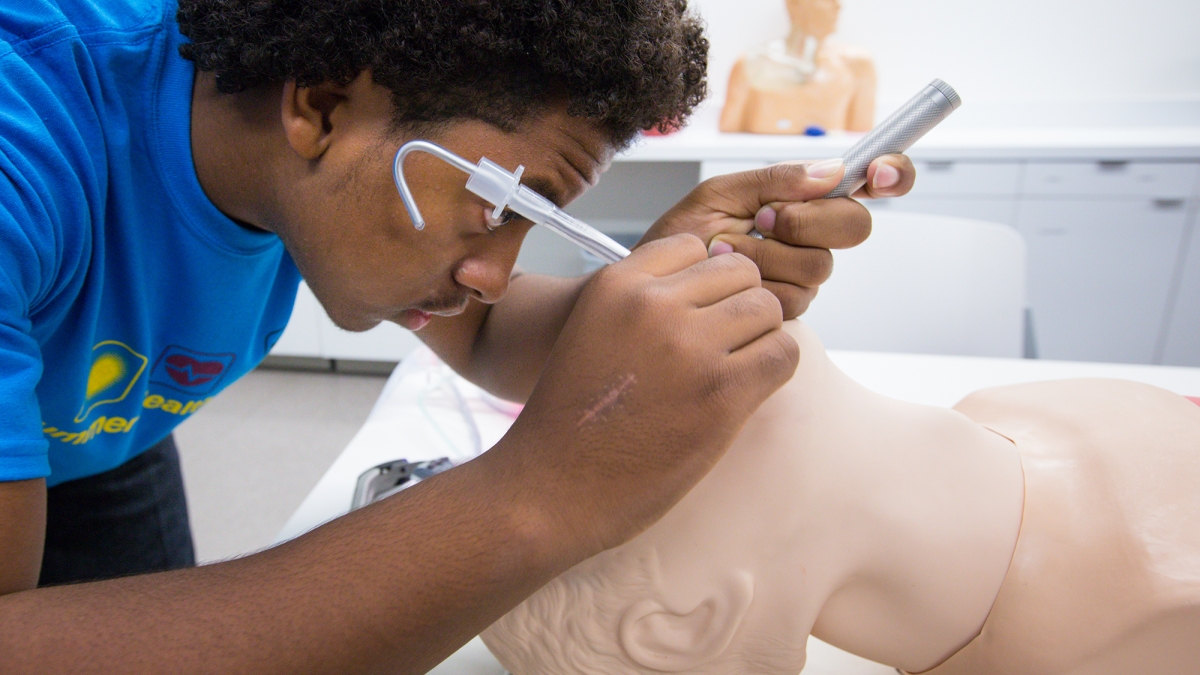 student practices intubation on a medical manikin