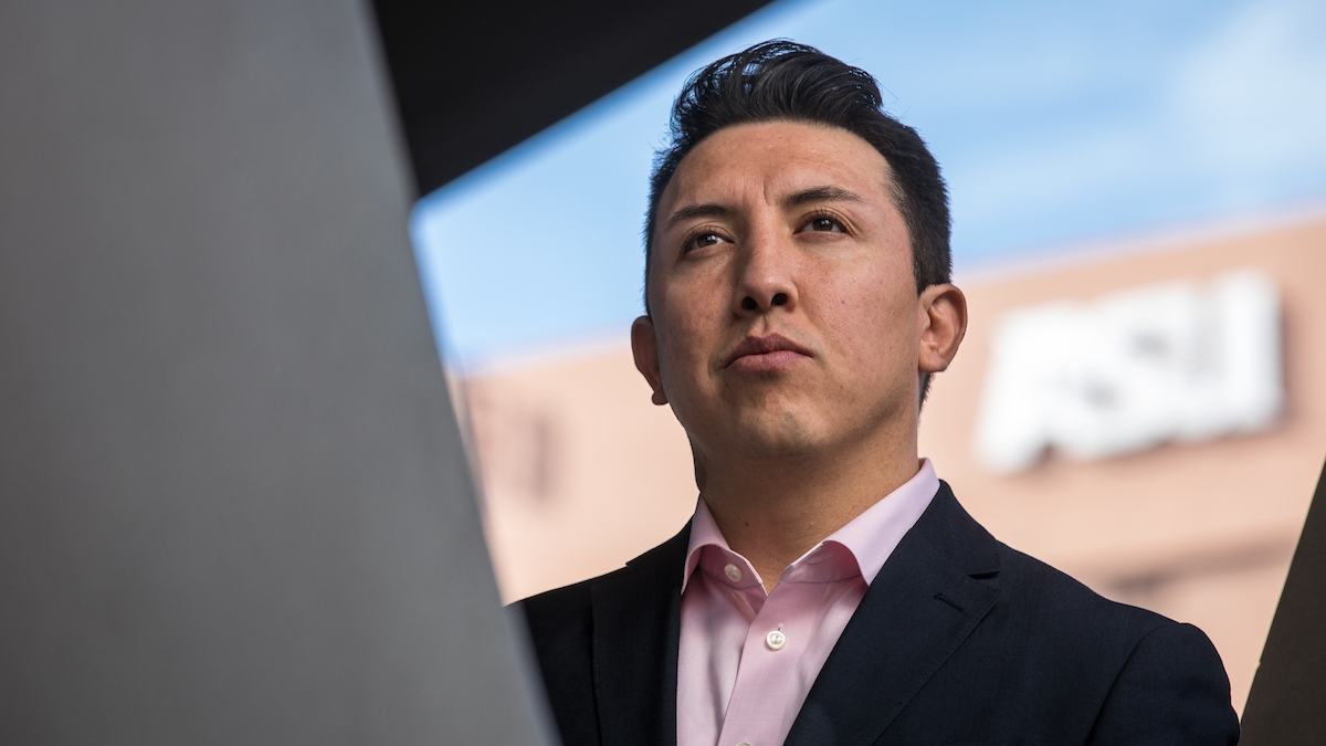 Young man with building in the background