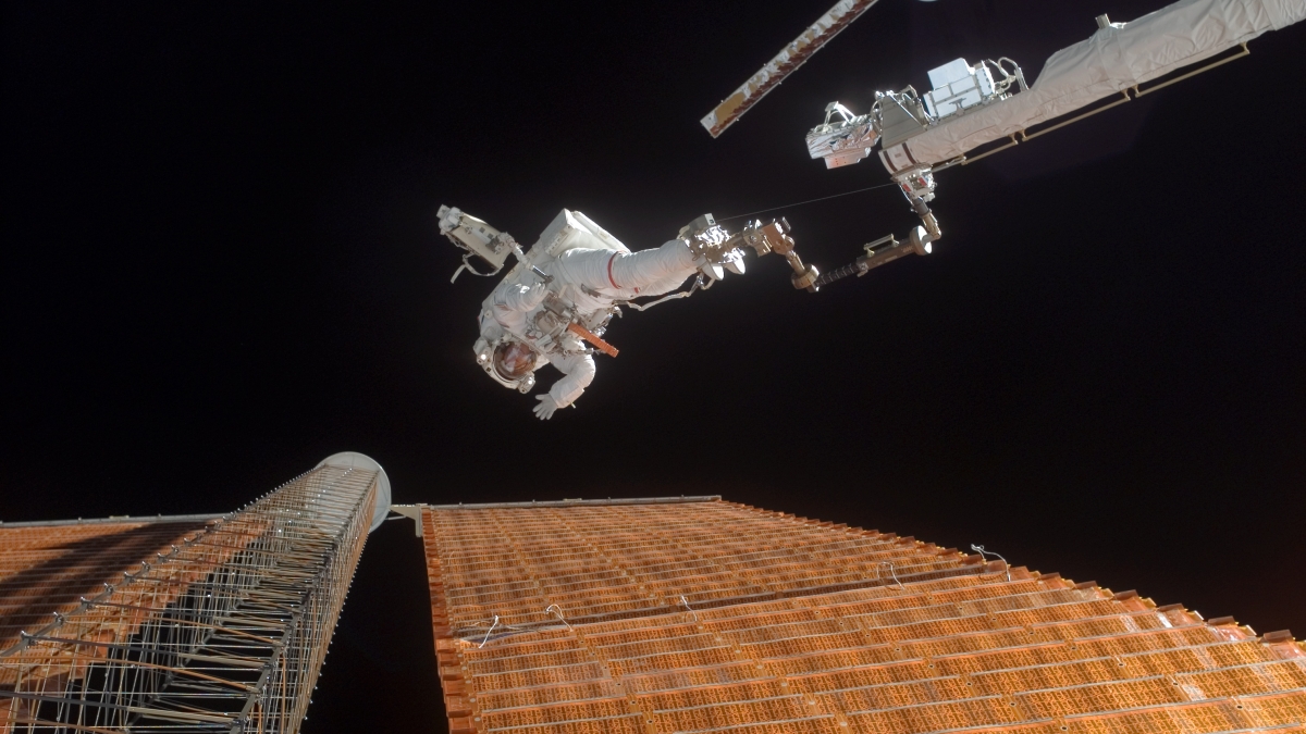 Astronaut Scott Parazynski repairs a damaged solar panel on the International Space Station.