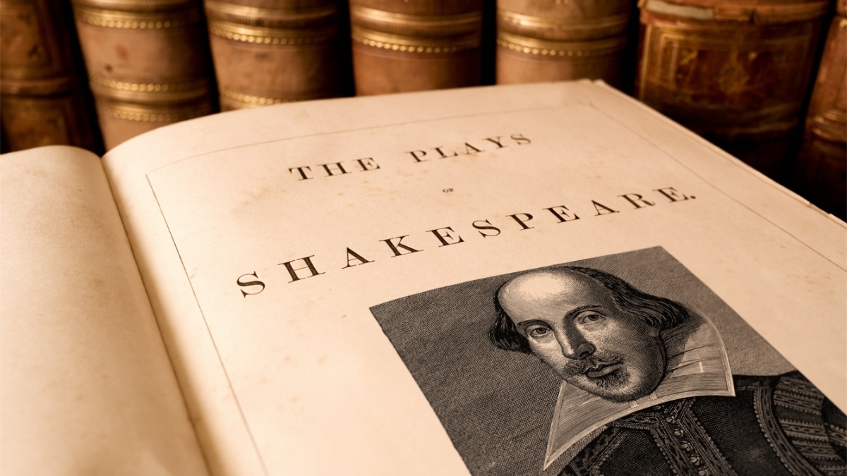 Book open to a page with a photo of William Shakespeare that reads, "The Plays of Shakespeare."