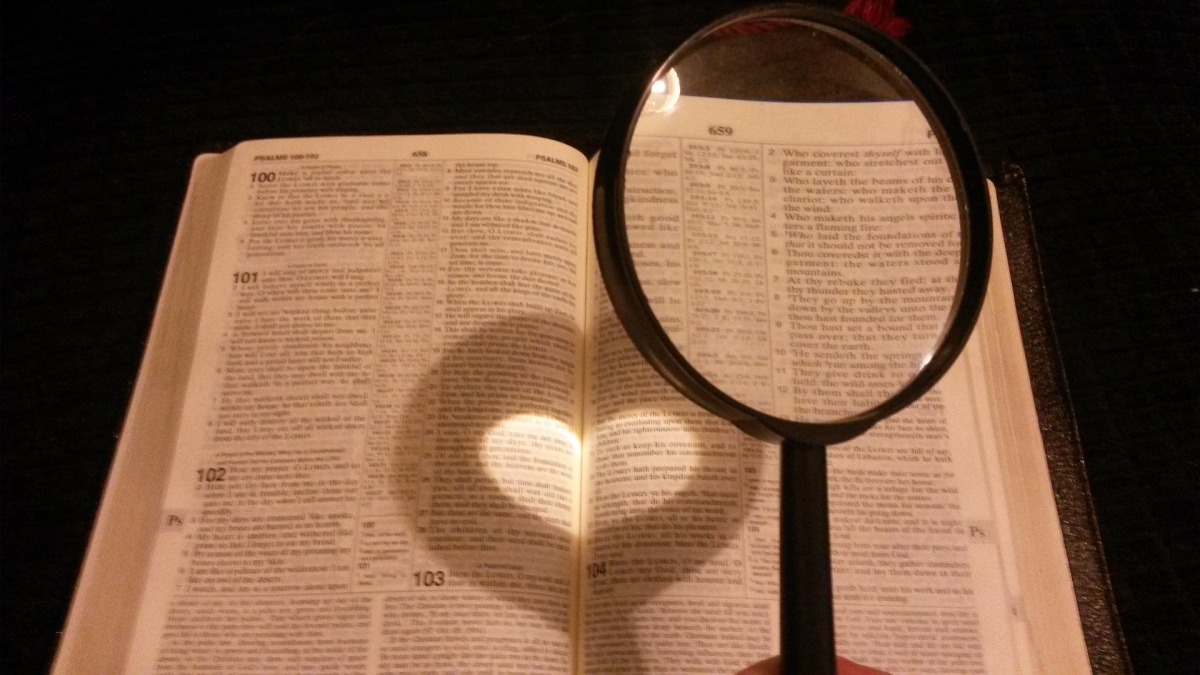 magnifying glass hovering over a book