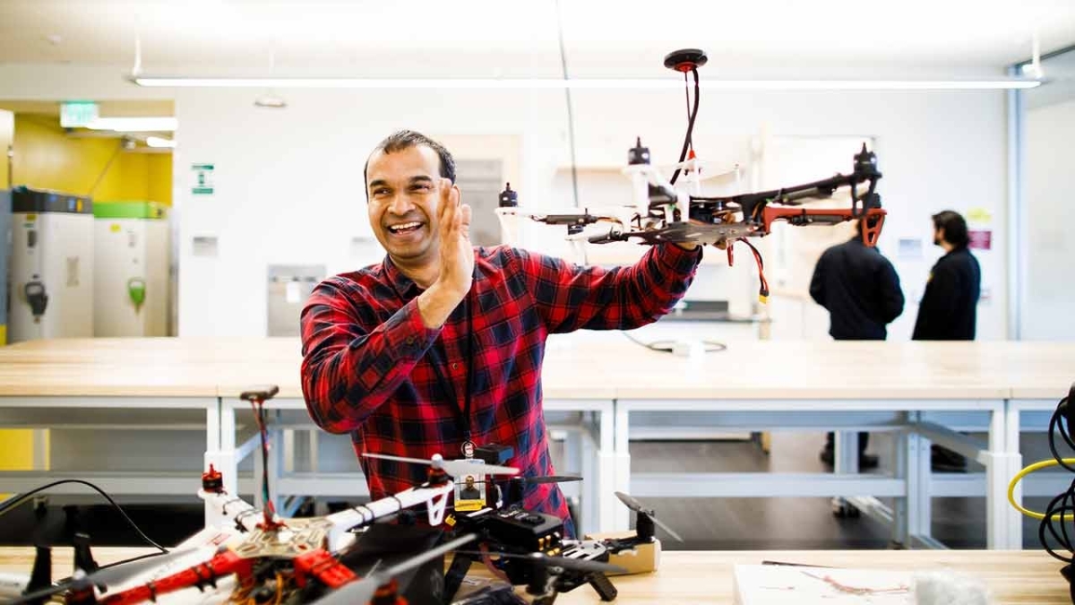 ASU Assistant Research Professor Jnaneshwar Das smiling and holding a drone