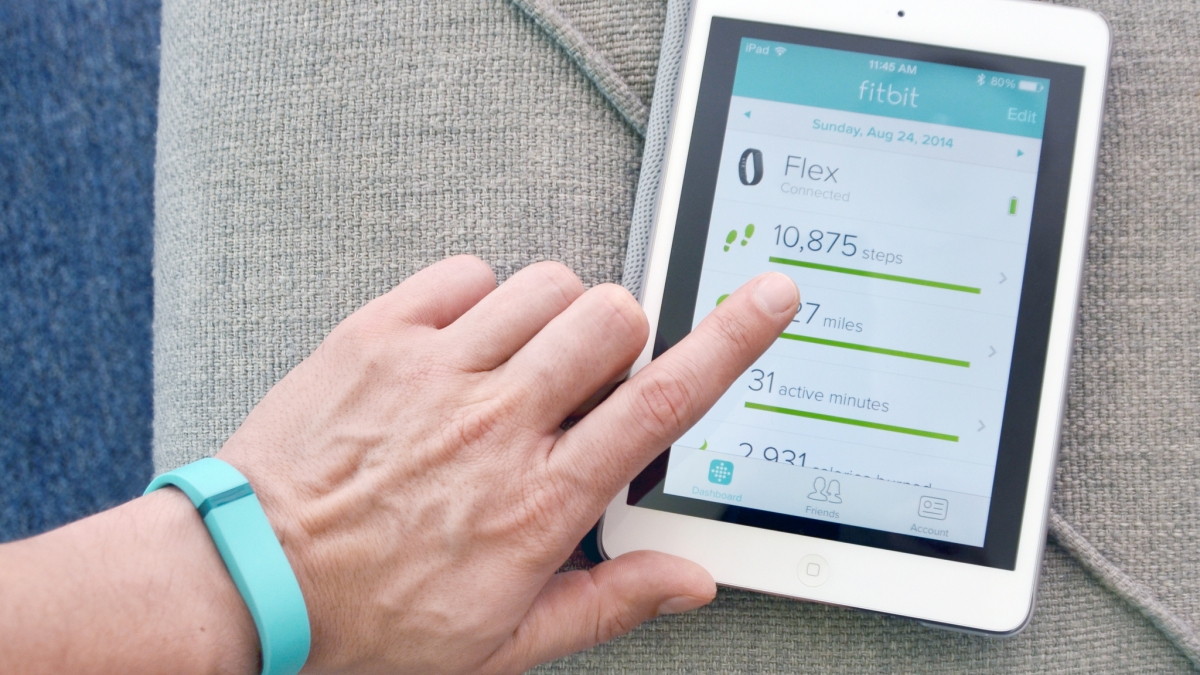 Hand hovering over a tablet displaying physical activity data.