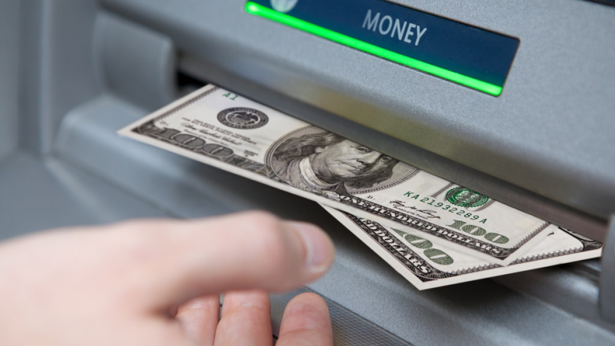 ATM machine dispenses cash
