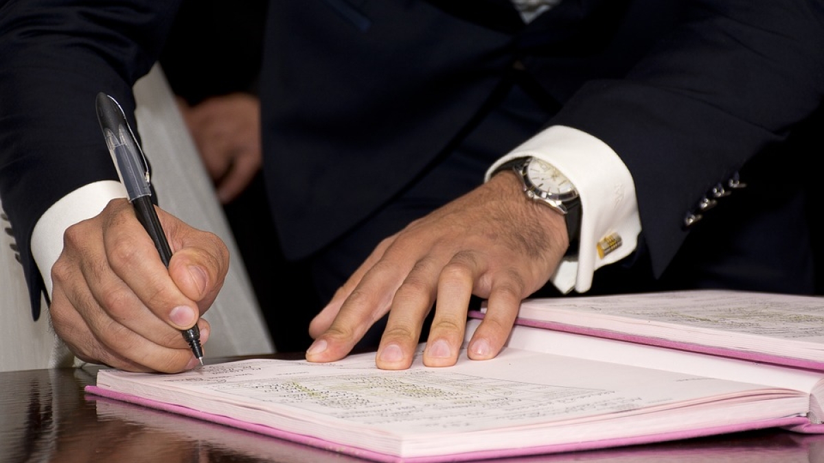 Man signing papers