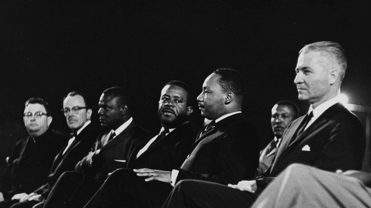 MLK and other men sitting in a row