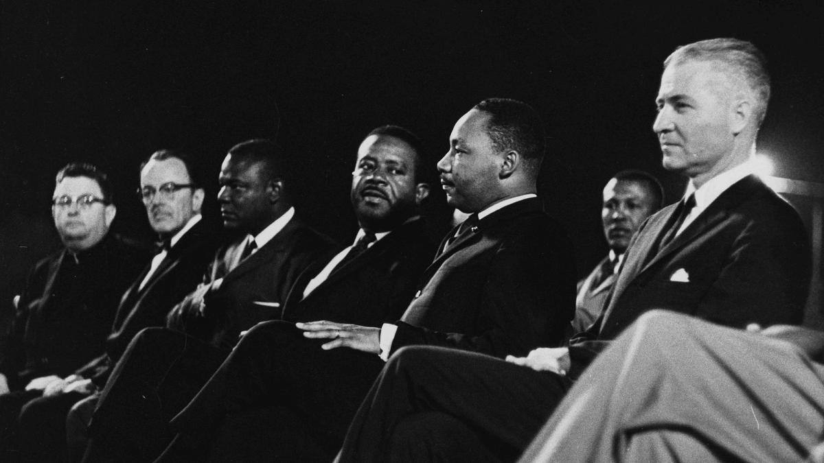 MLK and other men sitting in a row