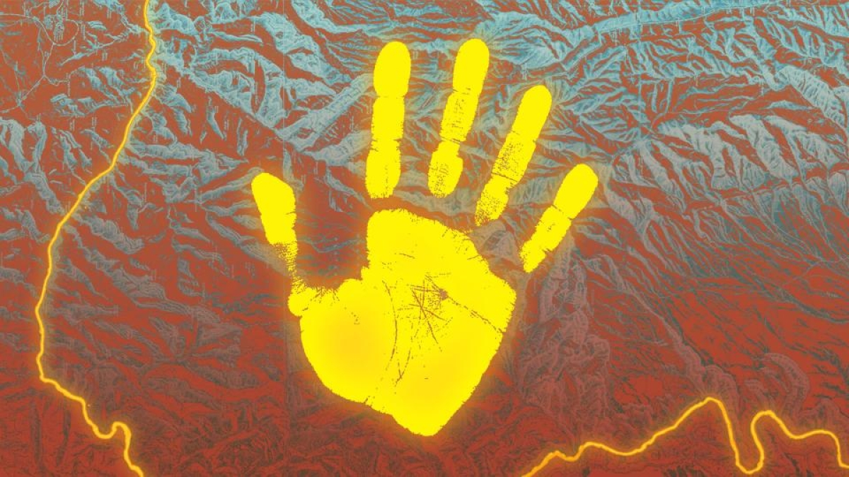 yellow handprint against backdrop of mountain topography