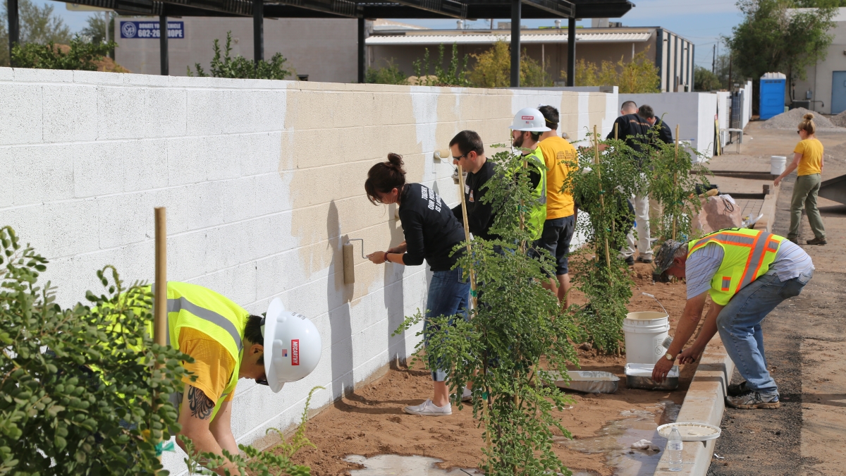 volunteers painting wall