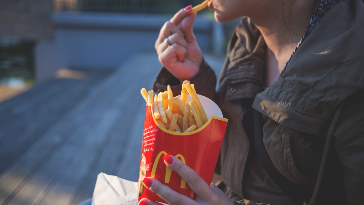 A woman eats McDonalds fries
