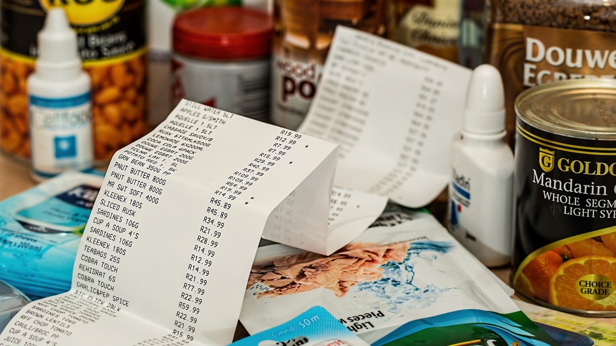 various groceries in background, receipt in foreground