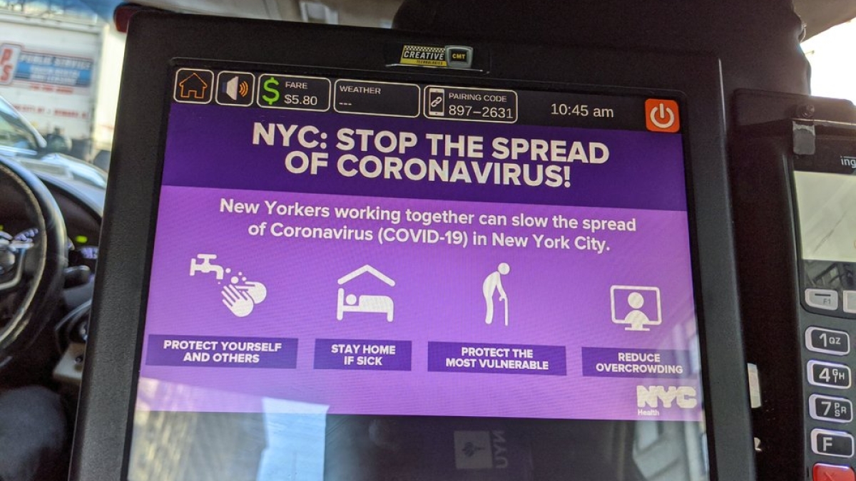 screen in taxi with information on how to stop the spread of coronavirus