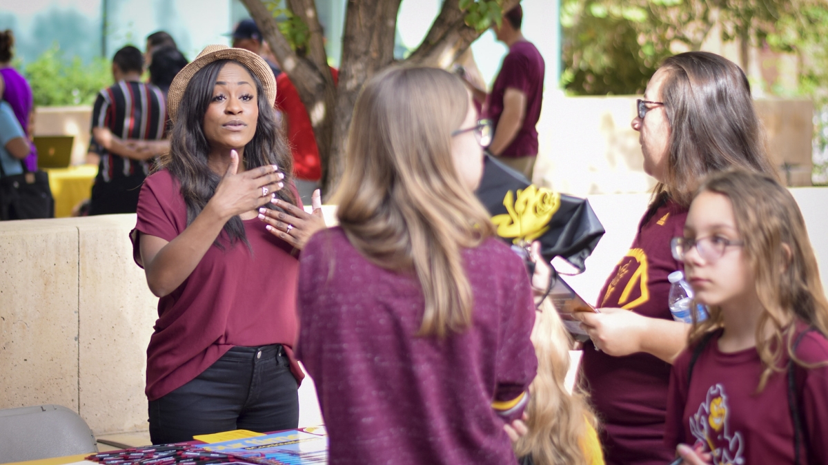 Women talk at a table at an ASU early outreach event on the Tempe campus