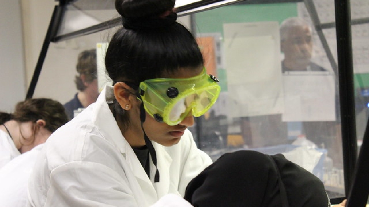ASU 2019 Arizona Science Olympiad student in goggles and lab coat