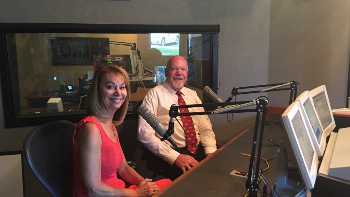 ASU Prep Digital CEO Julie Young and retired Utah Sen. Howard Stephenson sit in front of radio mics
