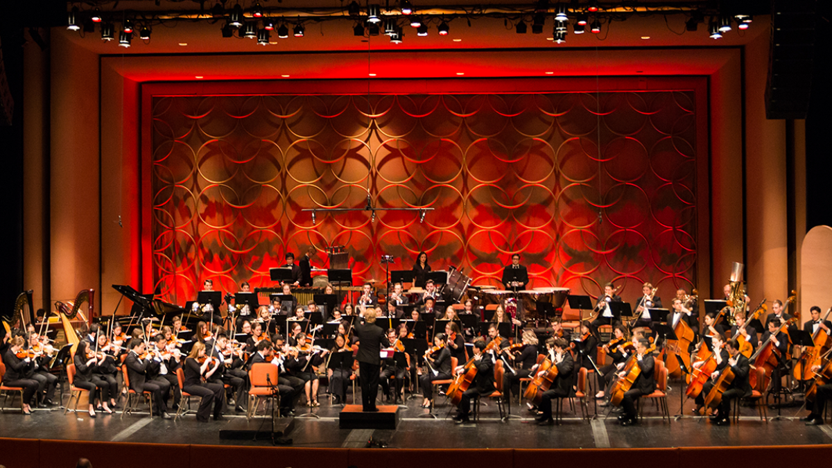 symphony playing music on a stage