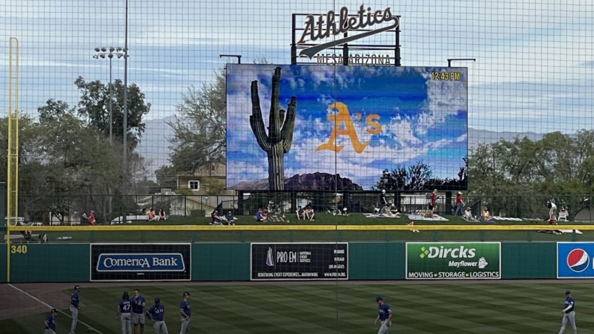 Spring training score board with desert graphic and Oakland A's logo