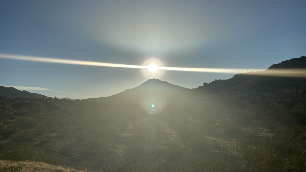 The sun rises over a mountain in a border landscape / Photo courtesy Martiza Estrada
