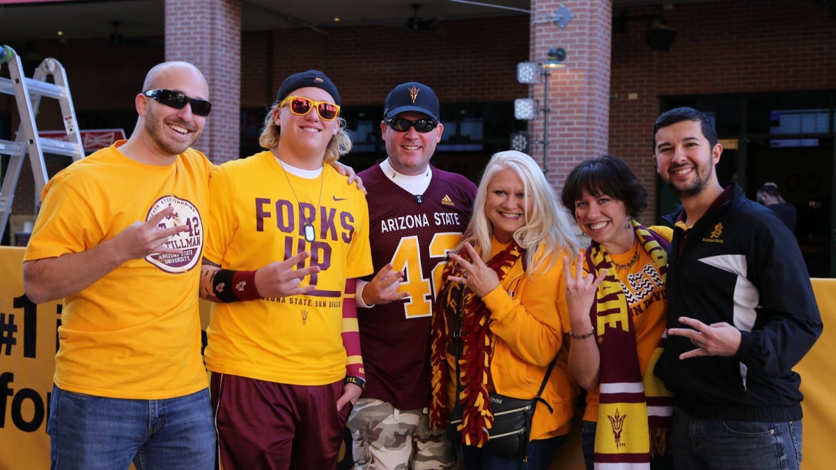 ASU Fulton Schools Business Relations Coordinator Anna Wales and her friends and family wearing ASU branded clothing at the 2016 Cactus Bowl football game at Chase Field.