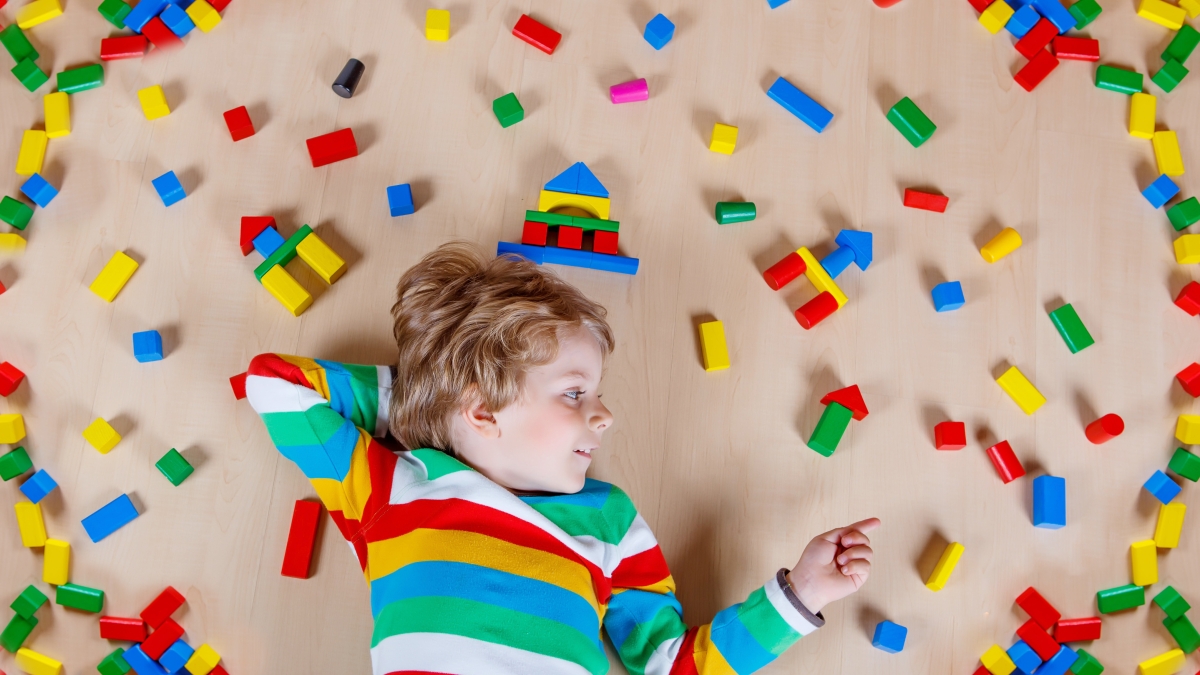 A preschool child plays with blocks