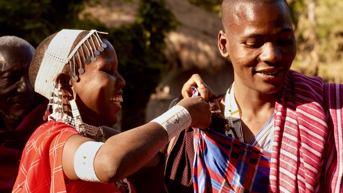 people of the Maasai tribe smiling and dressing for a celebration