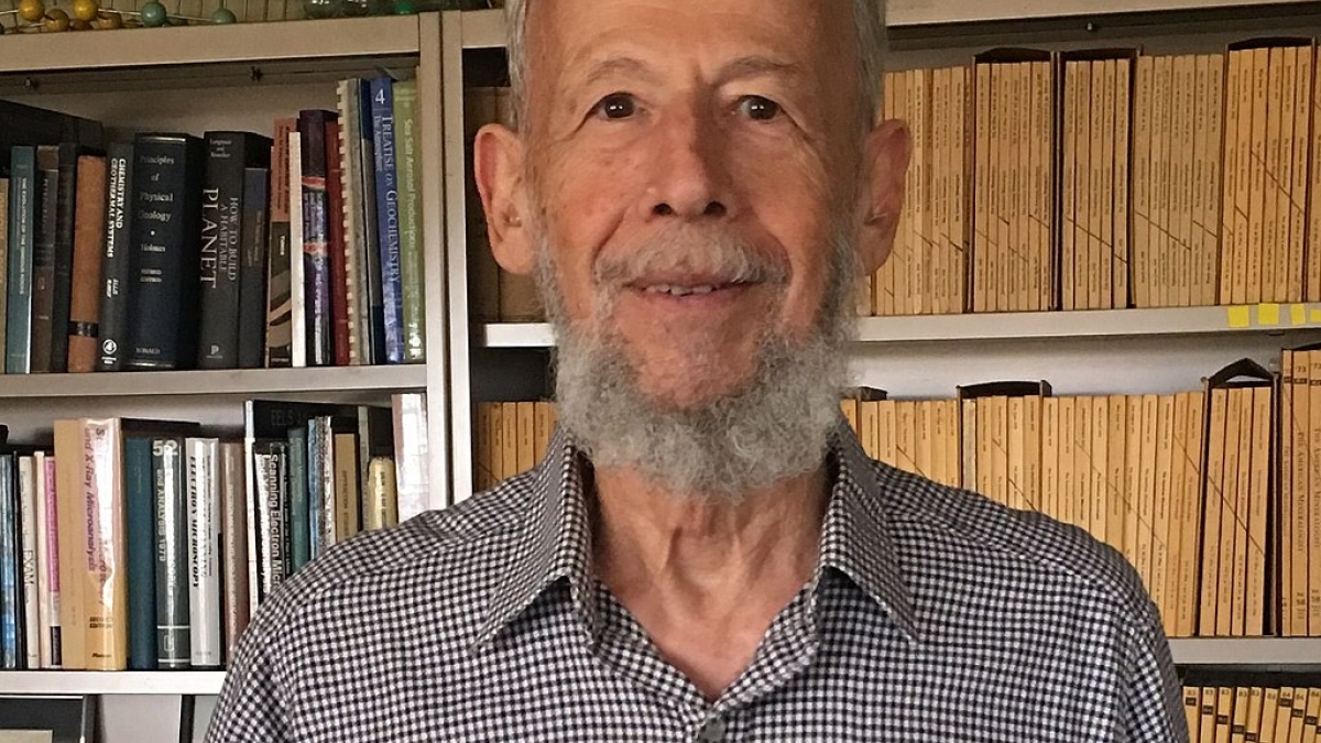 Headshot of Peter Buseck in front of a bookcase.