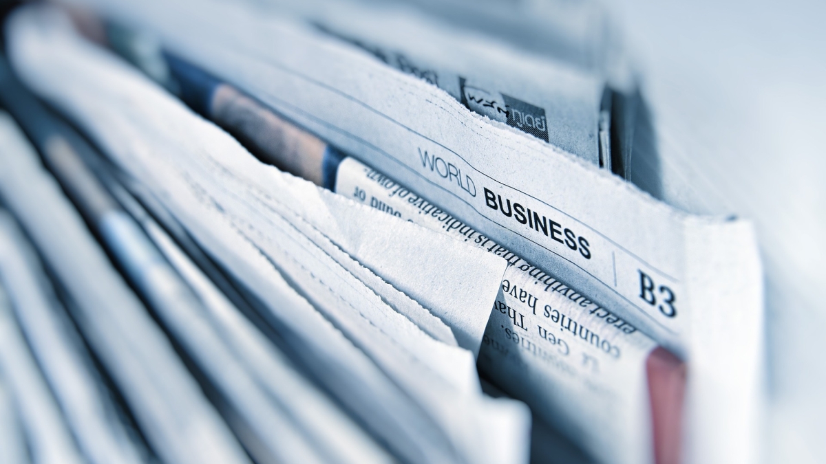 Stack of newspapers with business section sticking out