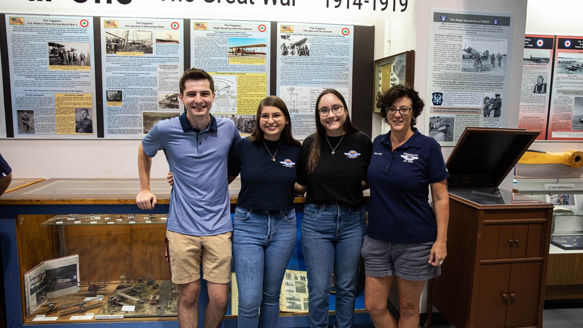 Aidan Lynch, Marilyn Beresewicz, Karolina Marek and ASU Lecturere Valerie Adams stand in front of the WWI exhibit the students researched and developed on the Foggiani US pilots who trained in Italy.