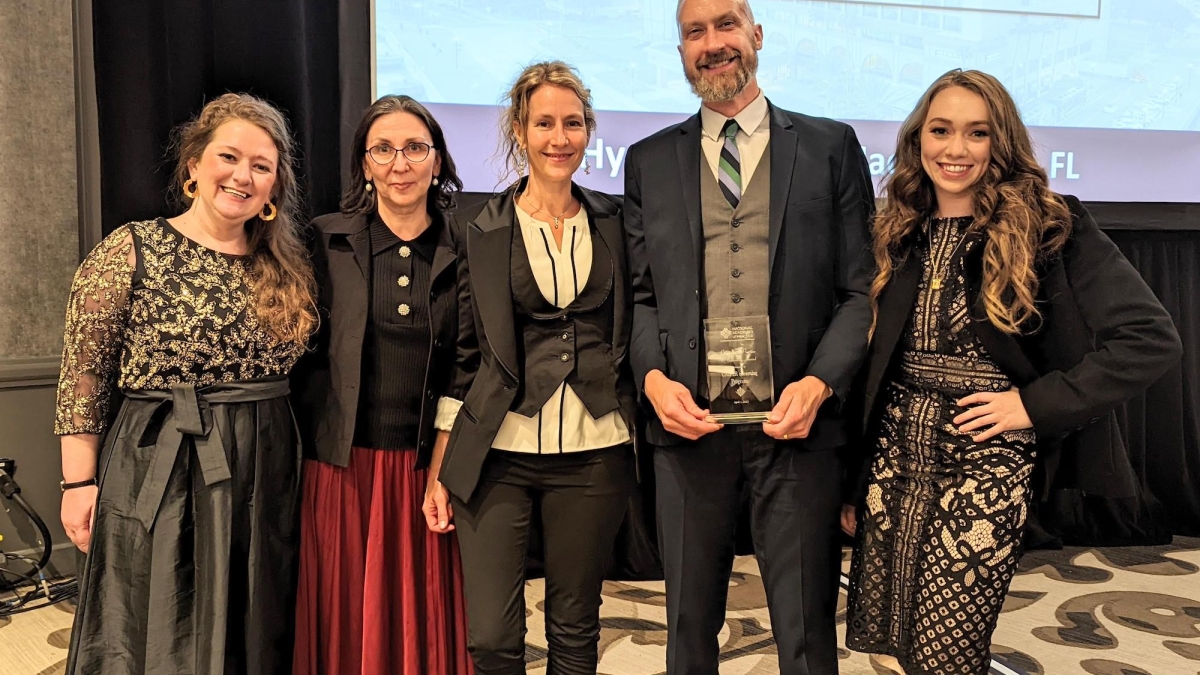 Group photo of CAIPER team holding an NAP award. 